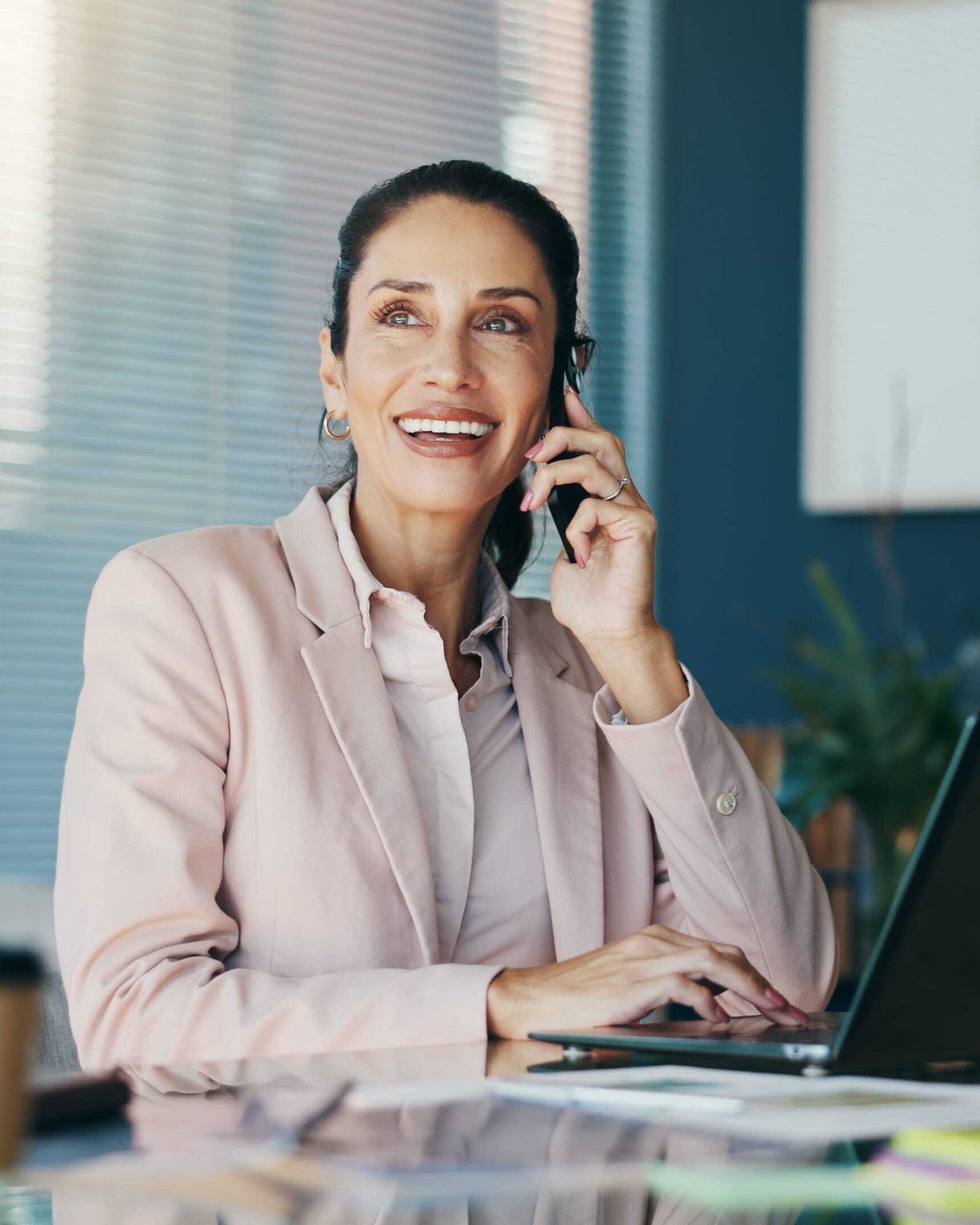 happy woman in office with laptop for planning_1484860460