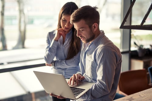 employees-looking-at-laptop