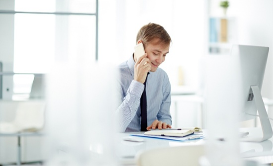 sales-person-on-phone-and-computer-1-1